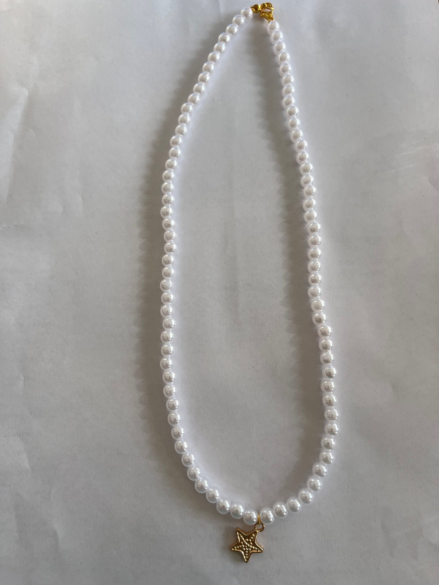 Pearl necklace with a star charm